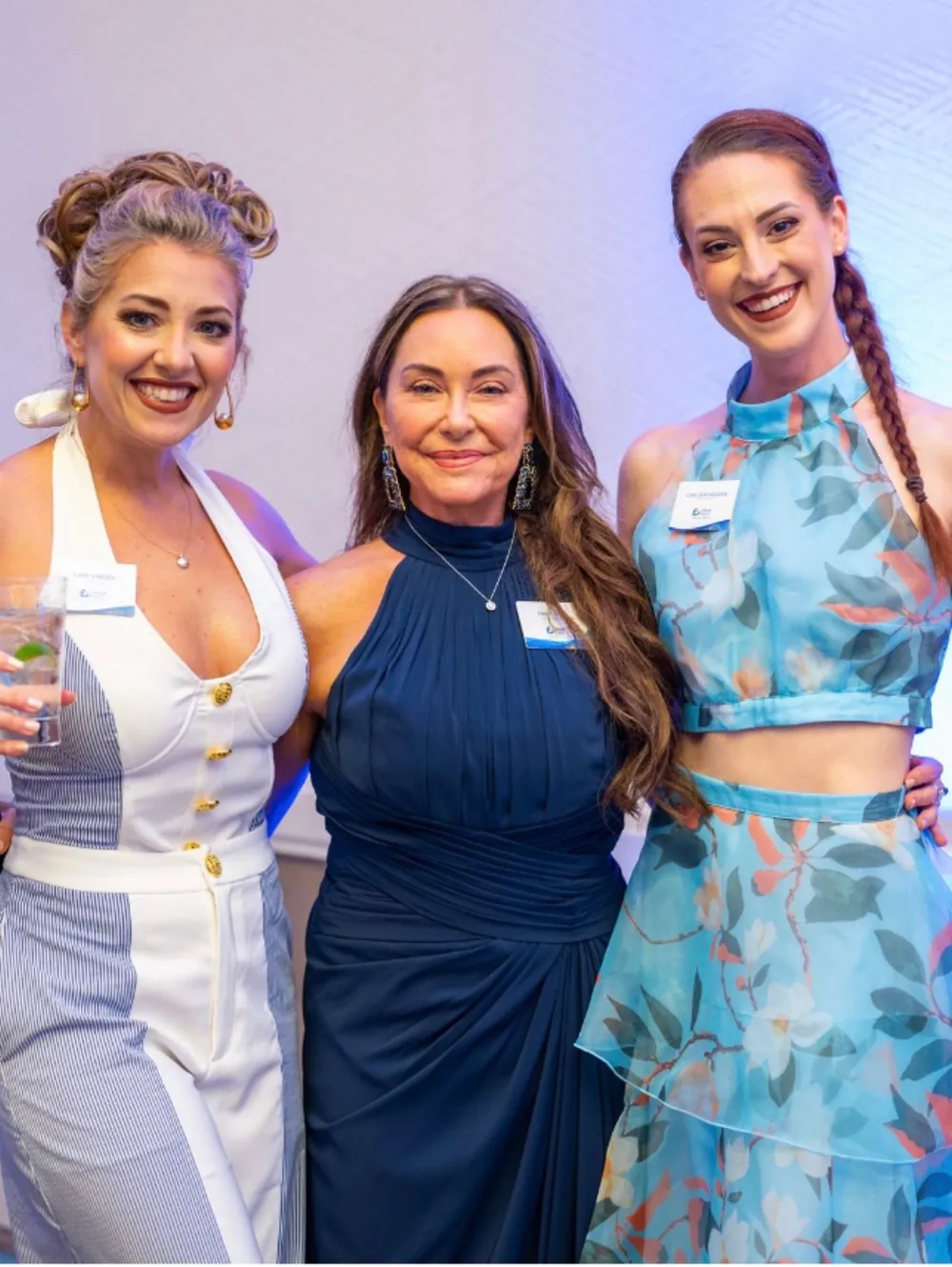 Three guests pose together during the evening.