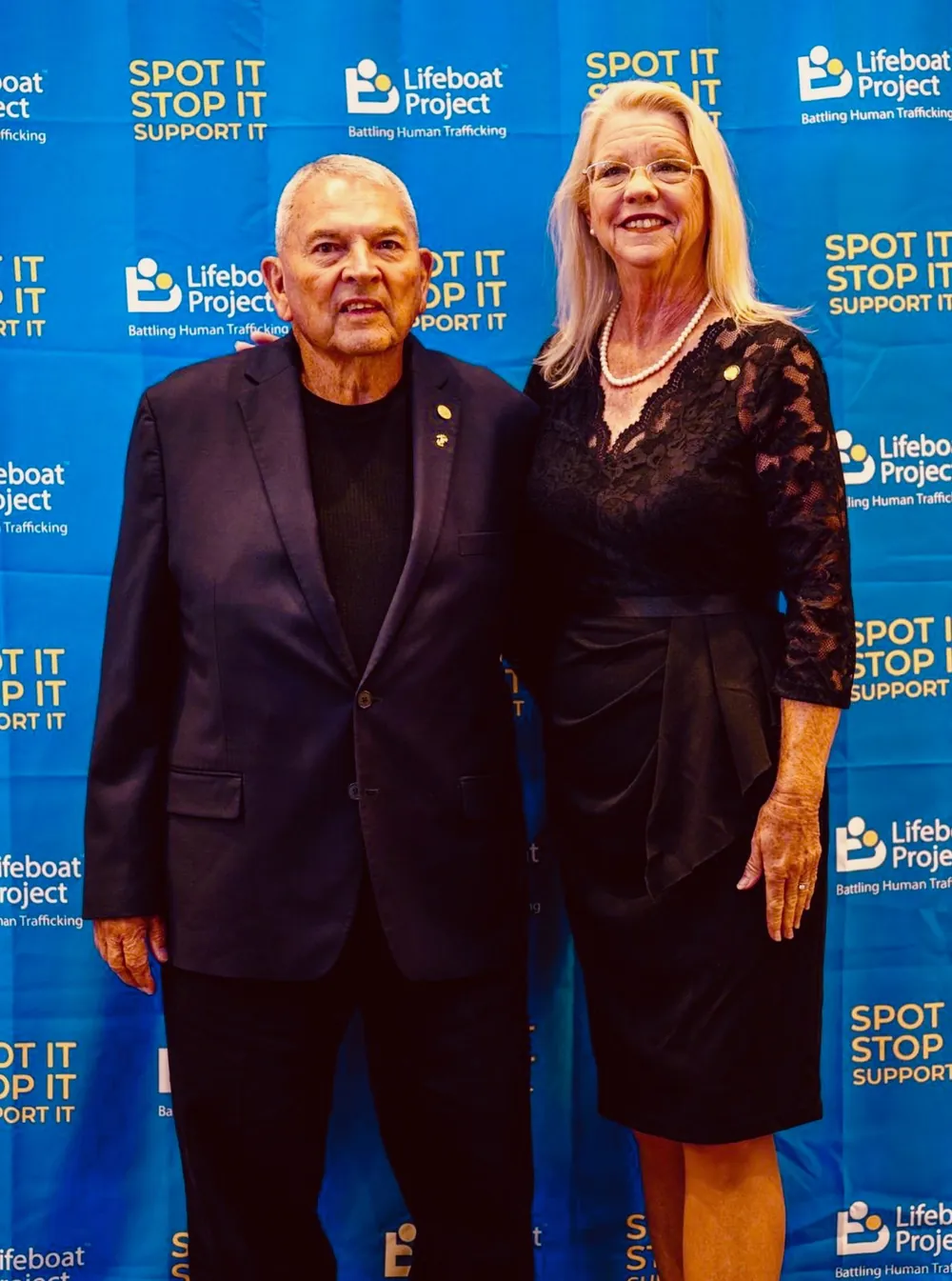 Two guests smile together at the Lifeboat photo backdrop.